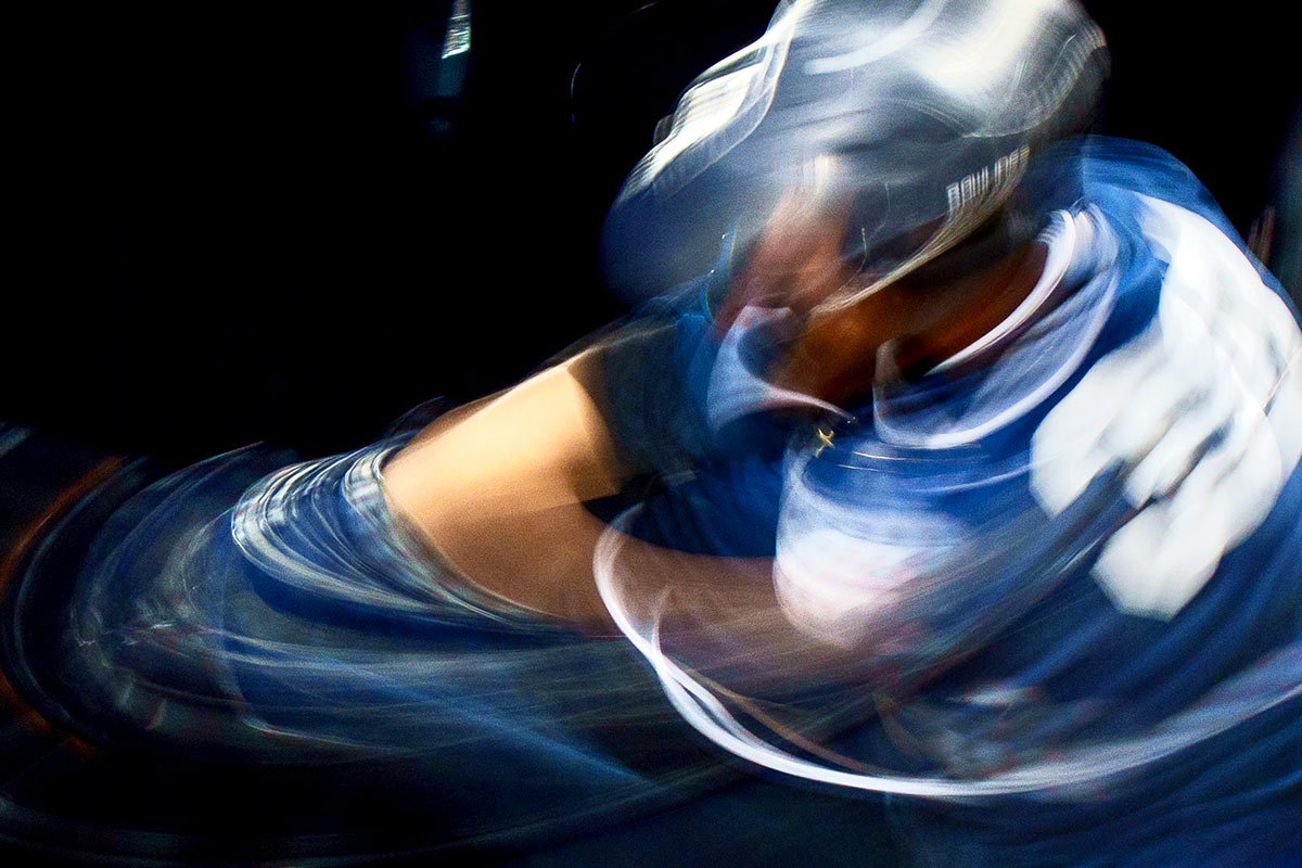 A blurry shot of a baseball swing
