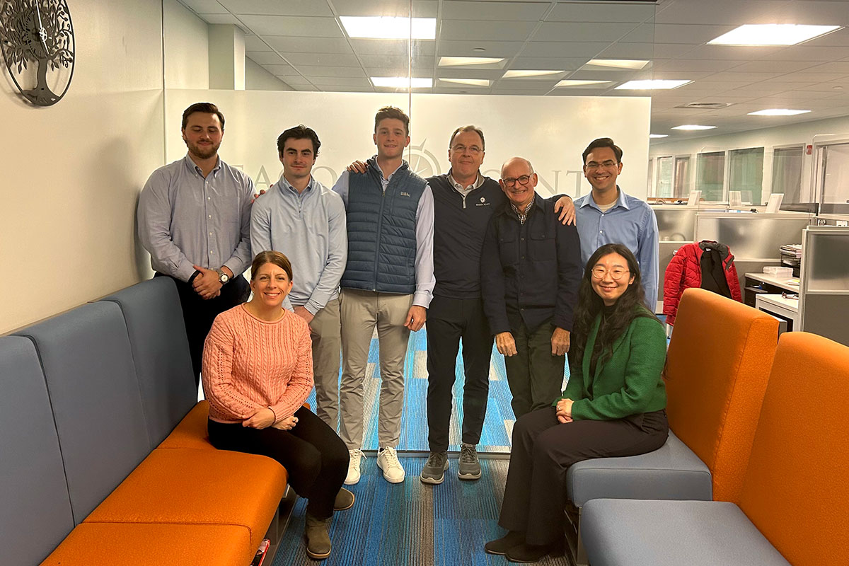 Matthew Chafin ’27 standing with Beacon Pointe staff in an office.