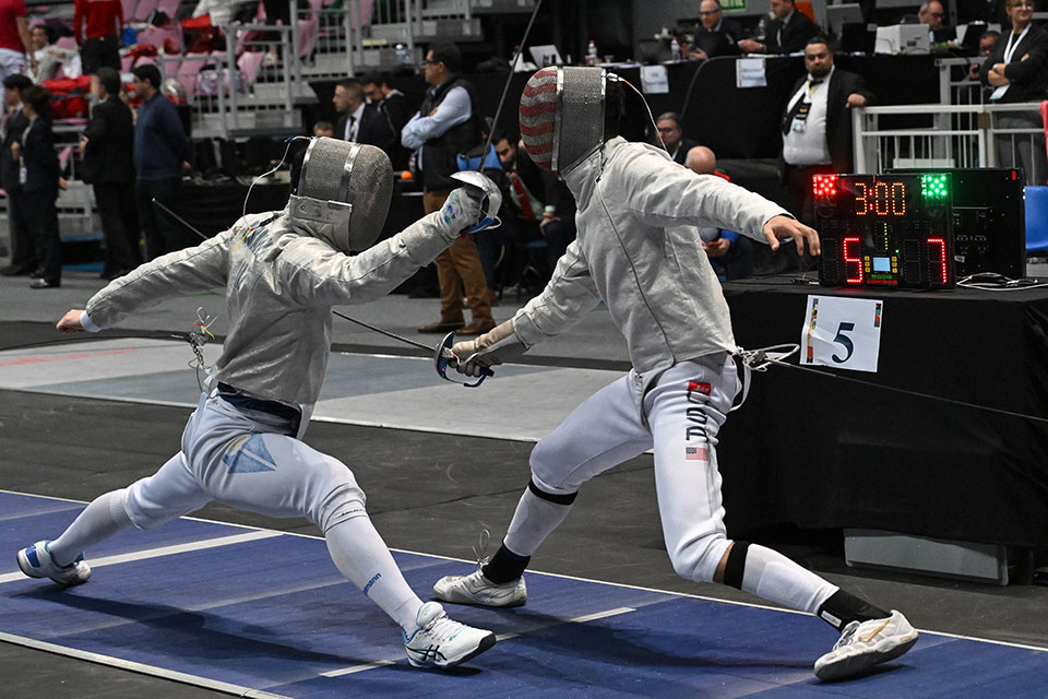 Lev BenAvram ’26 fences with an opponent during a fencing competition.
