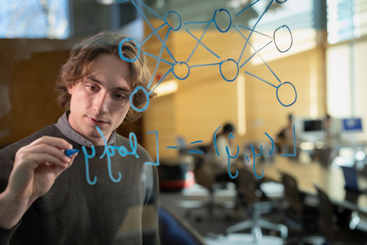 Ben Lambright ’24 writes an equation.