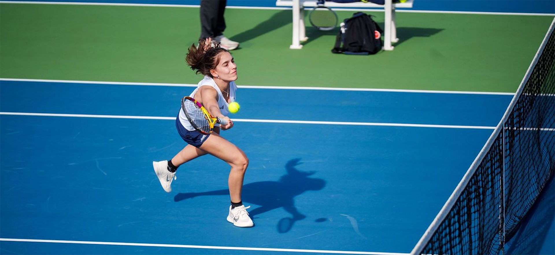 A tennis player competes in a tennis match.