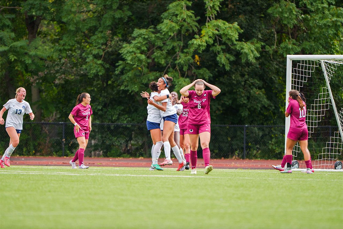 The women's soccer team celebrates after a big win.
