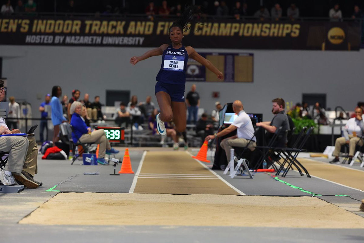A track and field athlete competes in the long jump.