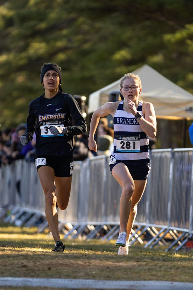 Two cross country runners run side by side.