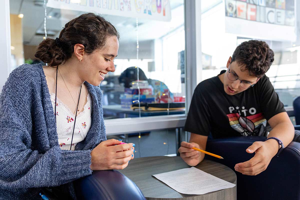 Two students in the Genesis program work together on a project