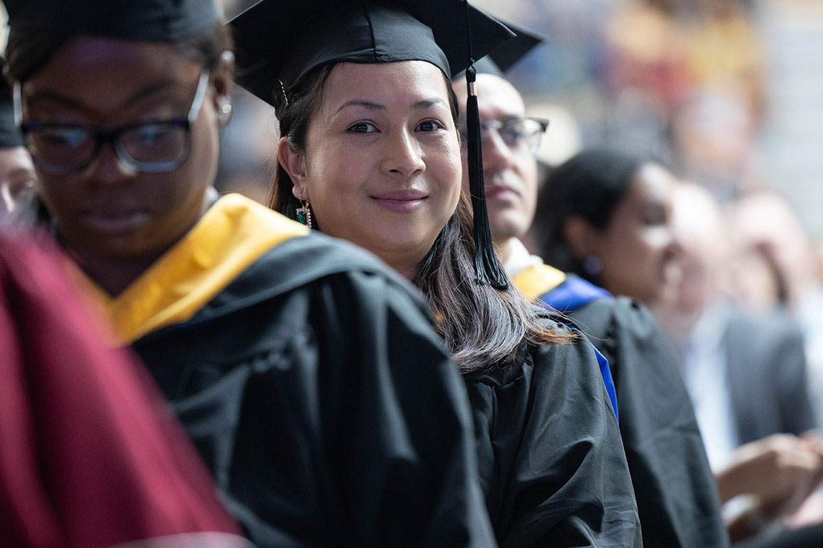 Graduates smile during Commencement