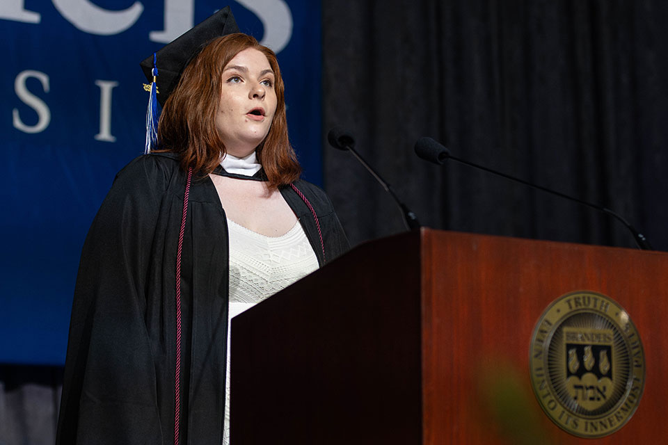 Nicole Emily Albright signs the national anthem on stage.
