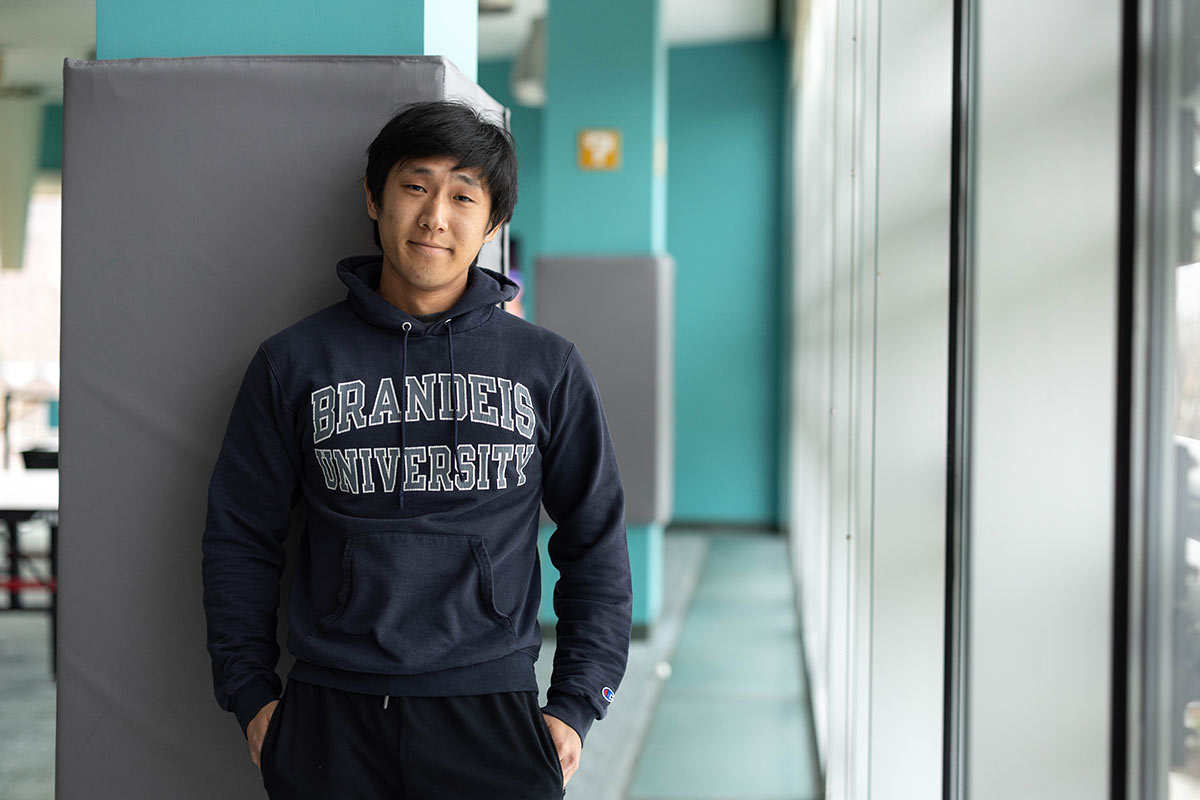 Patrick wears a Brandeis University sweatshirt