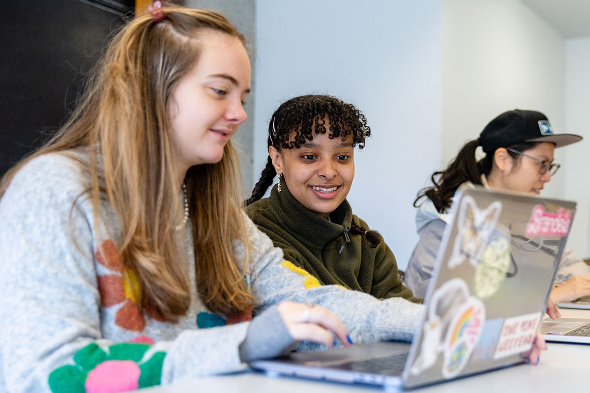 Students work on a laptop during Colleen Hitchcock’s first ever virtual exchange/collaborative online international learning class.