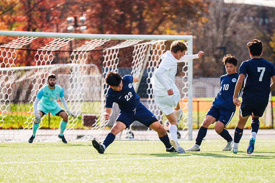 Kenshin Murakawa ’27, left, and Rainer Osselmann-Chai ’26 successfully block a shot from a Tufts striker.