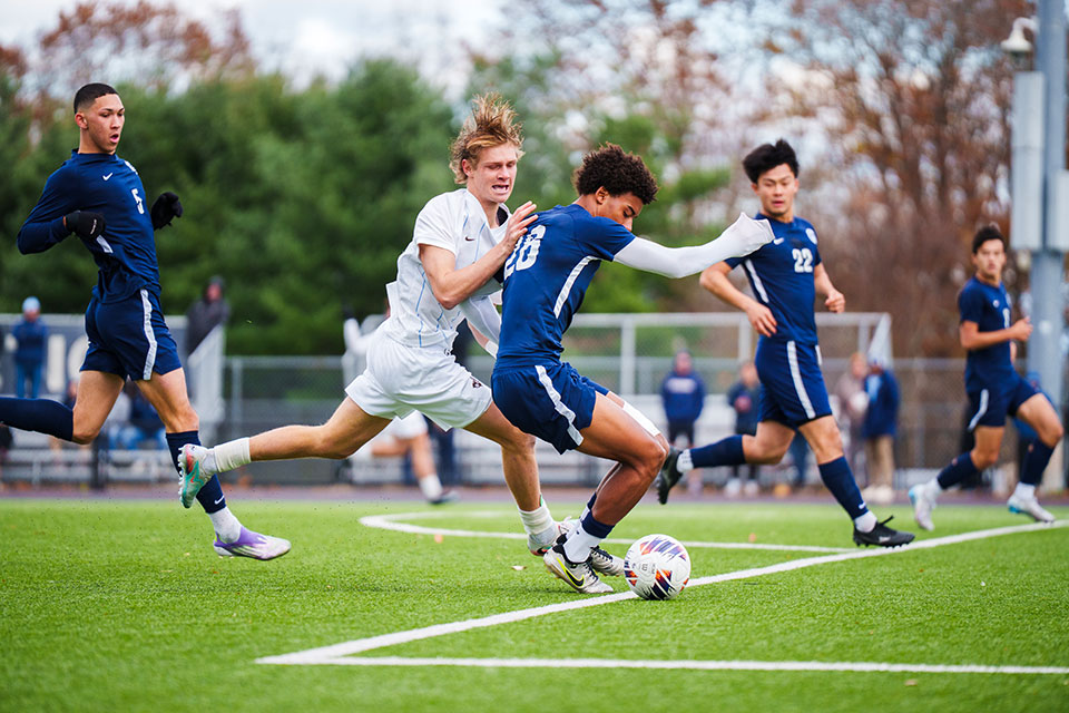 Kaden Collins ’28 shields the ball against a Tufts player.