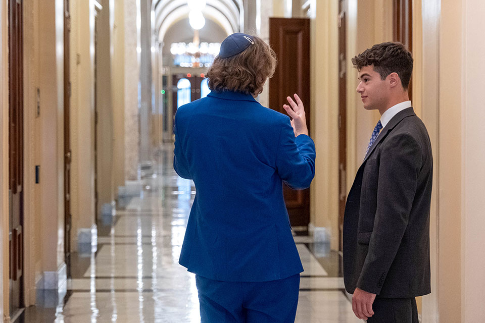 Noah Levy speaking with a colleague at his internship on Capitol Hill.