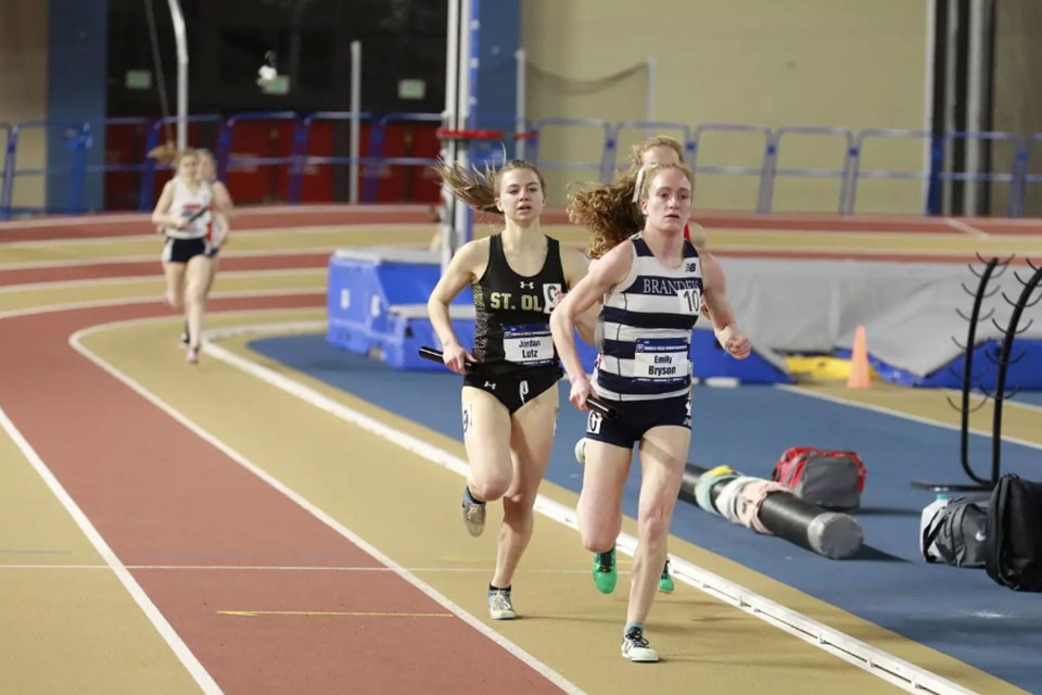 Emily Bryson running on a track.