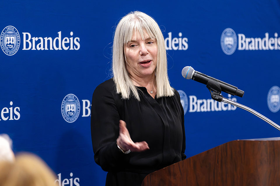 Marjorie Hass speaks at a podium.