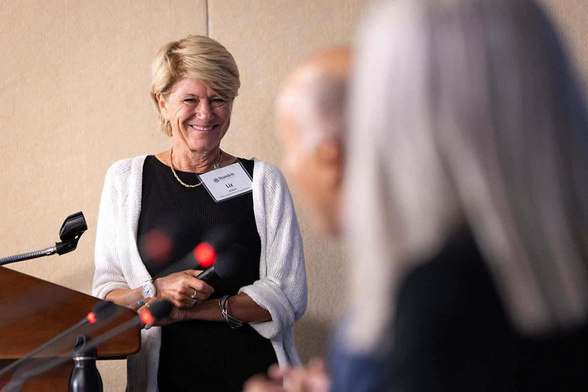 Liz Willen smiles at the podium