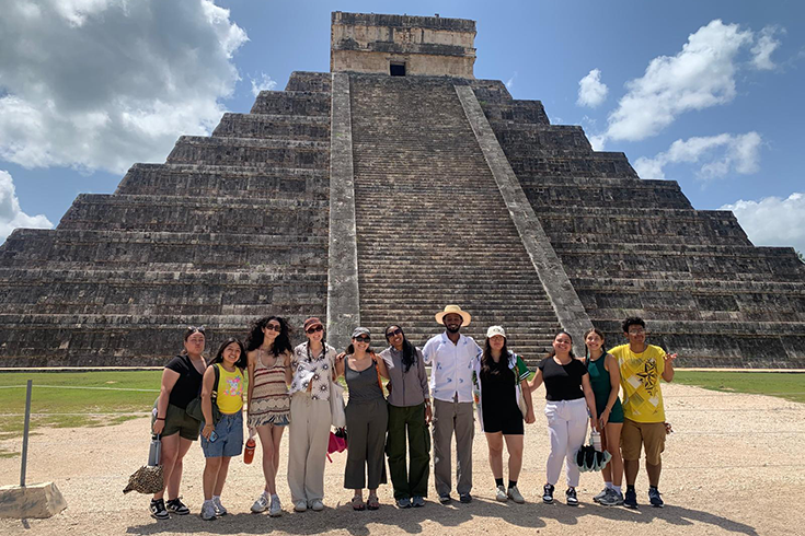 students in front of aztec pyramid