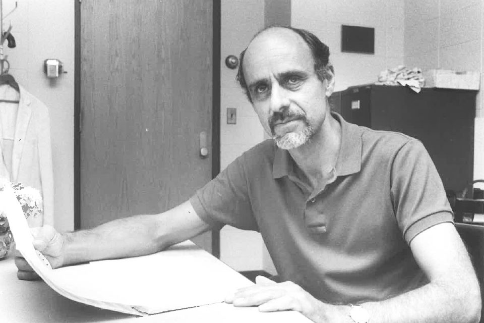 Peter Jordan sitting at a desk.