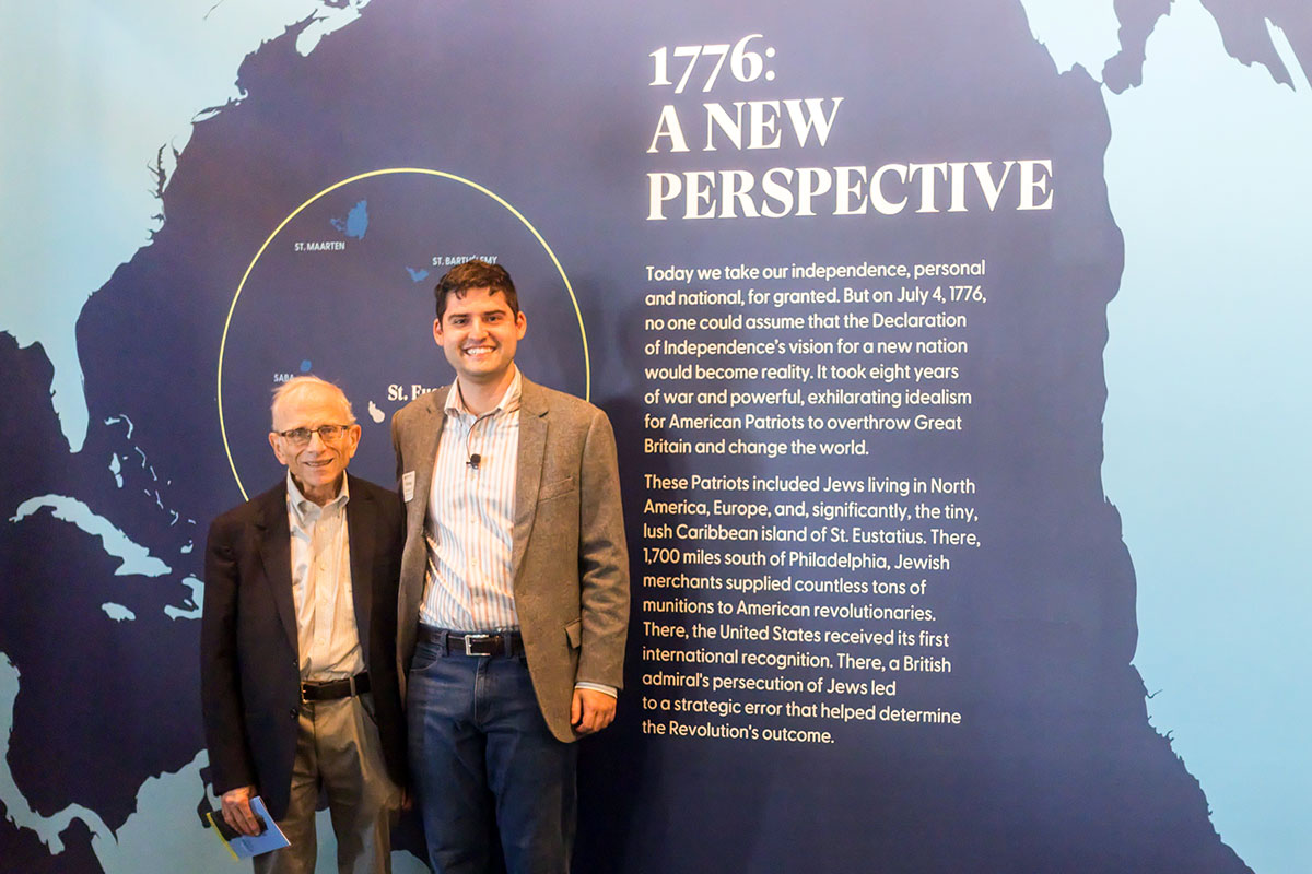 Jonathan D. Sarna and Elisha Gordan ’25 stand in front of "The First Salute" exhibit
