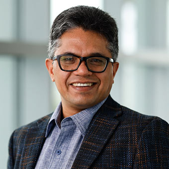 Prakash Kashwan standing by a window