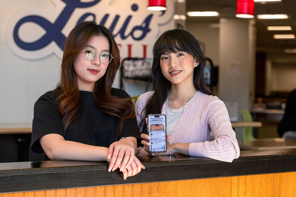 Two students holding a phone