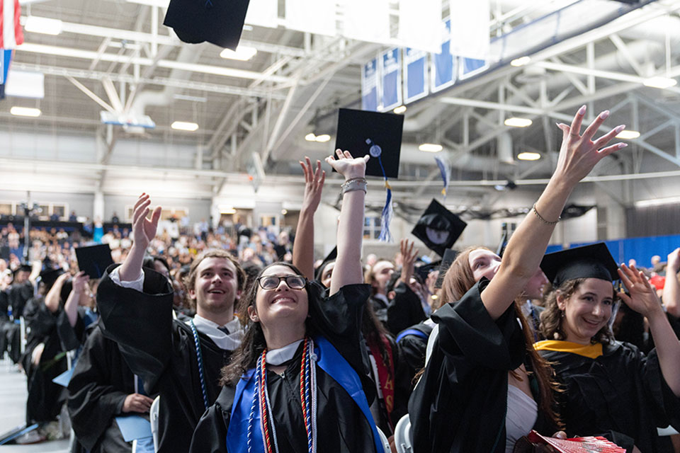 Students throwing up graduation caps