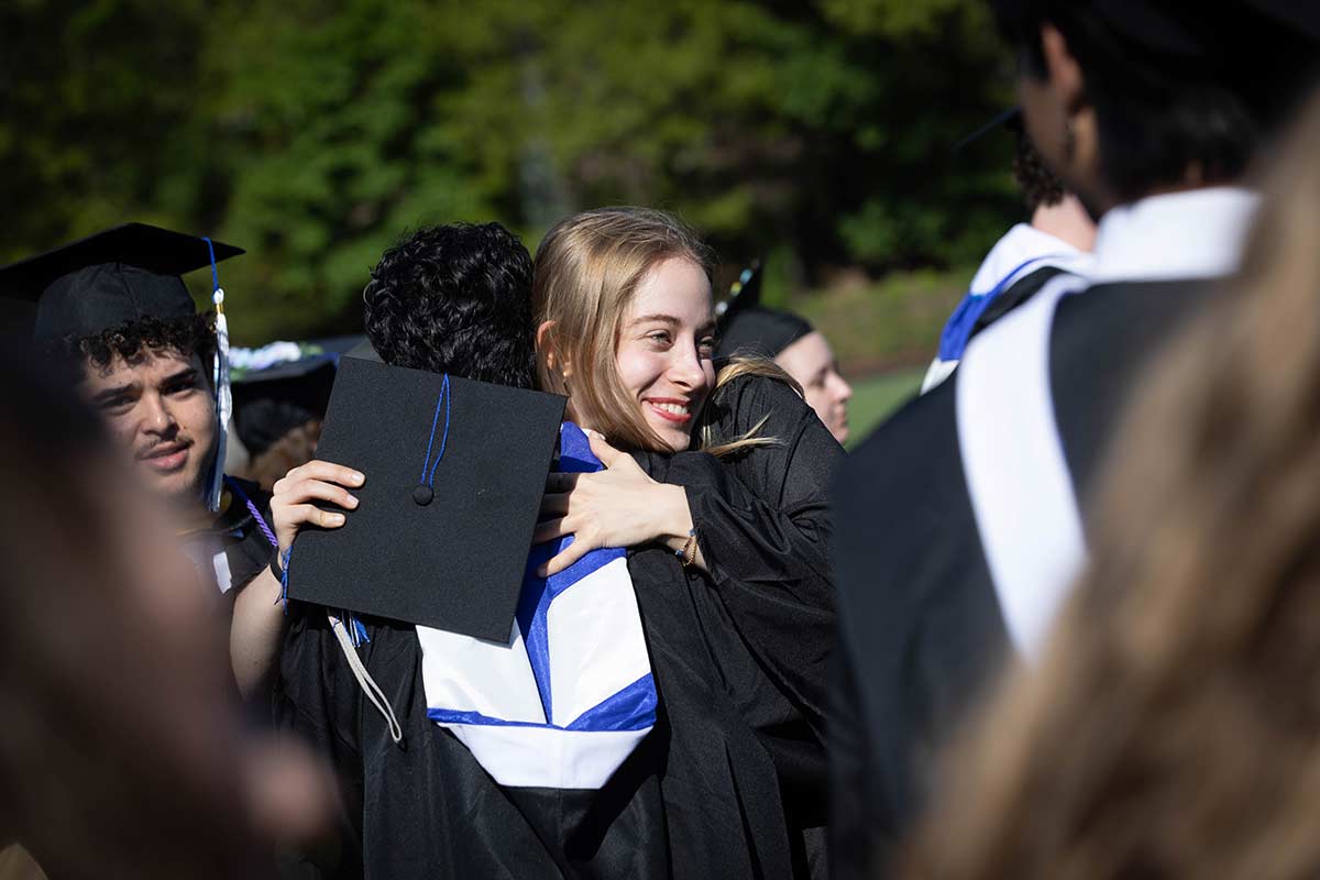 Students embrace one another outside