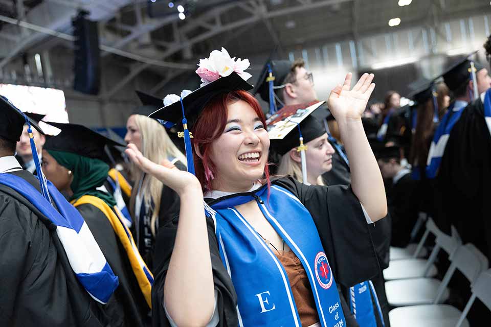 A graduate smiling