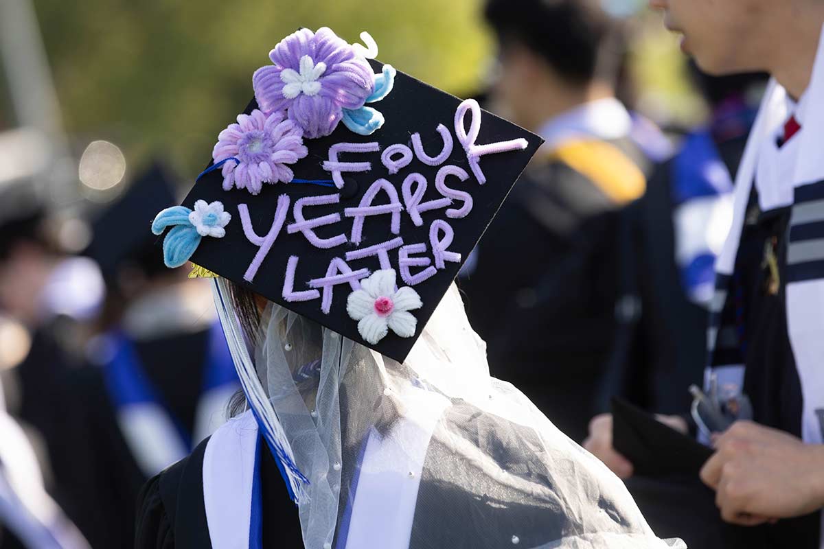 A decorated cap that reads: Four years later, in purpe