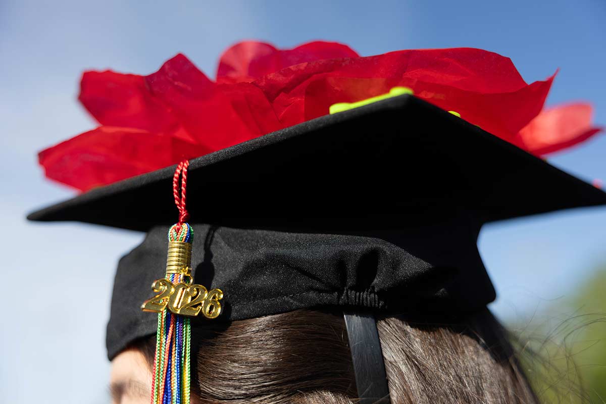 A decorated cap with red flowers, the 2026 tassel in view