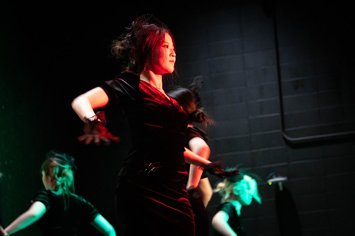 A student dances on stage during a Culture X performance.