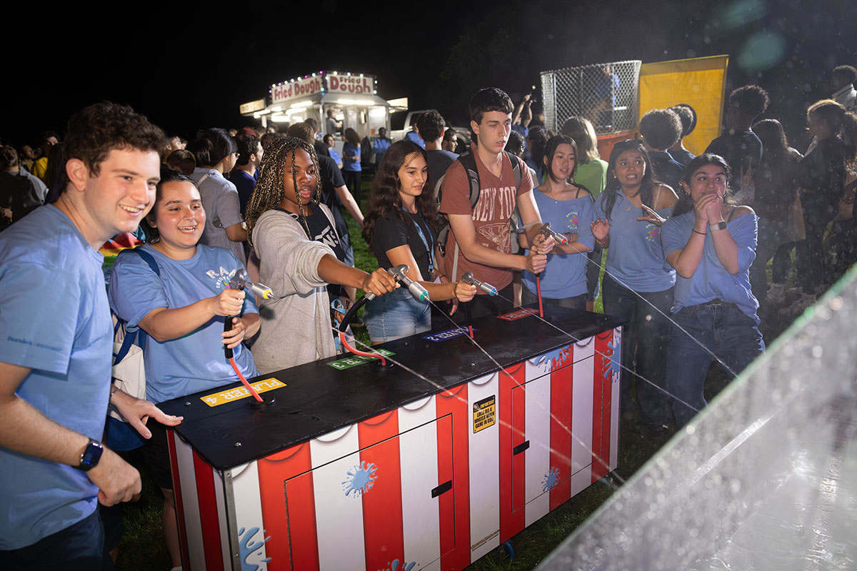 A group of students play a water carnival game.