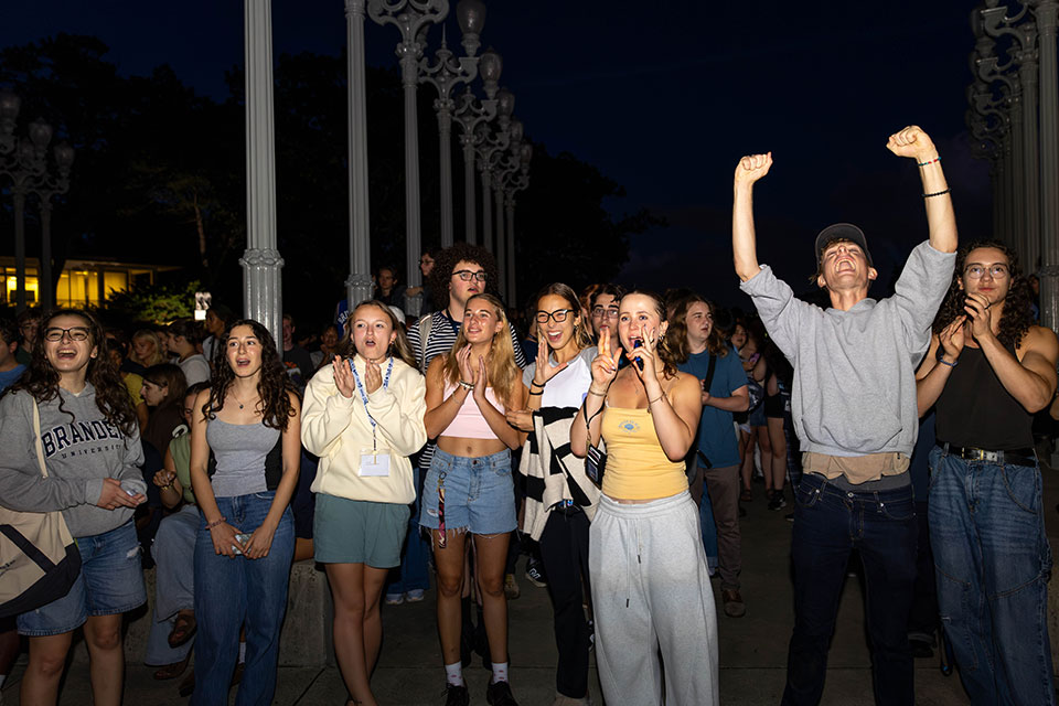 A group of students applaud and cheer.