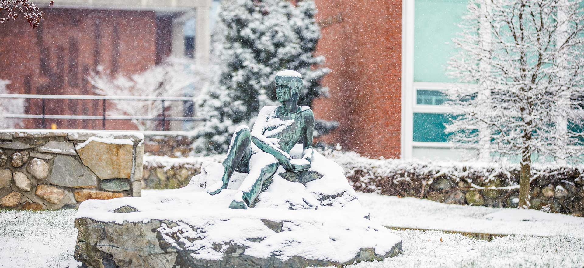 A statue on the Brandeis campus covered in snow.