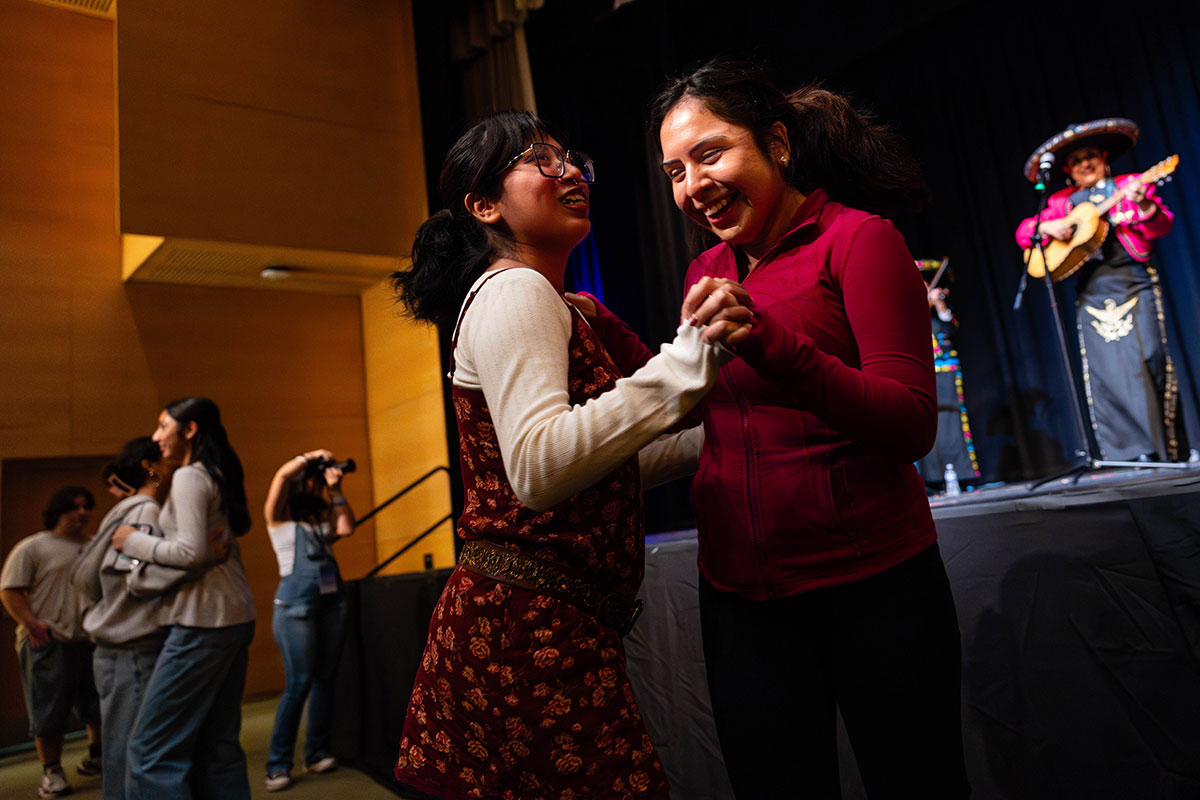 Two students dancing to a mariachi performance.