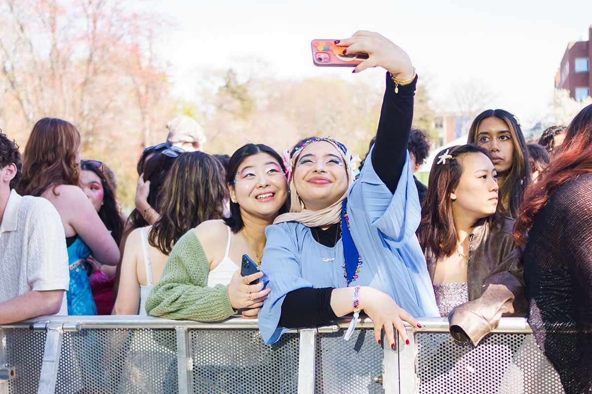Two students take a selfie in the audience at Springfest.