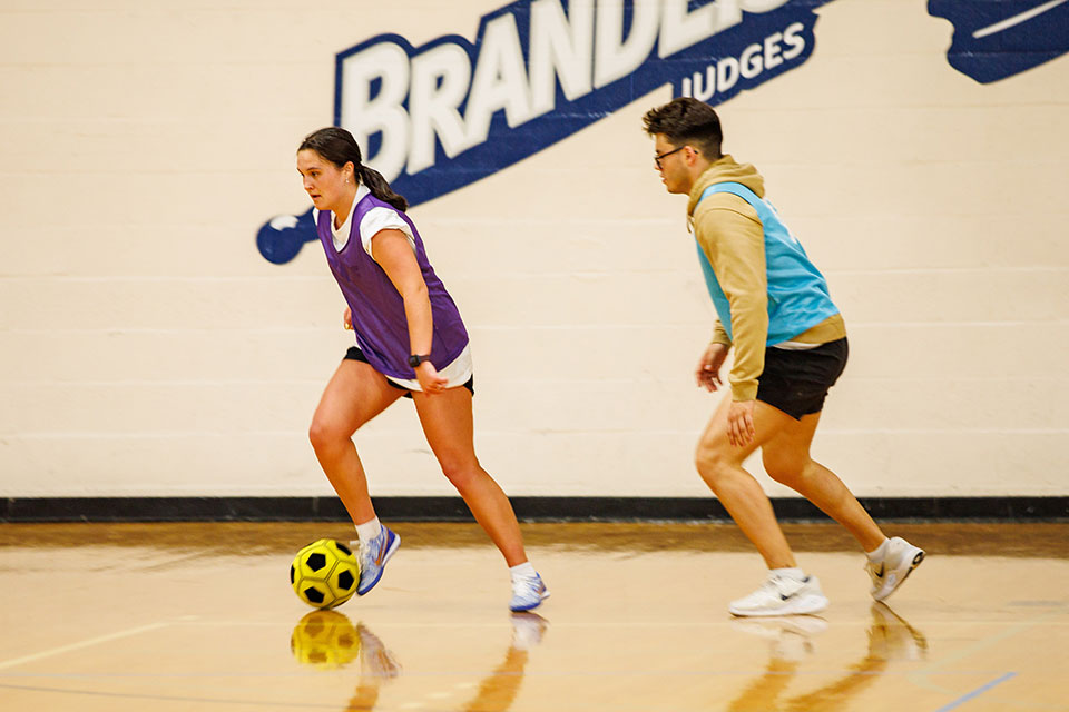 Students play indoors intramural soccer. 