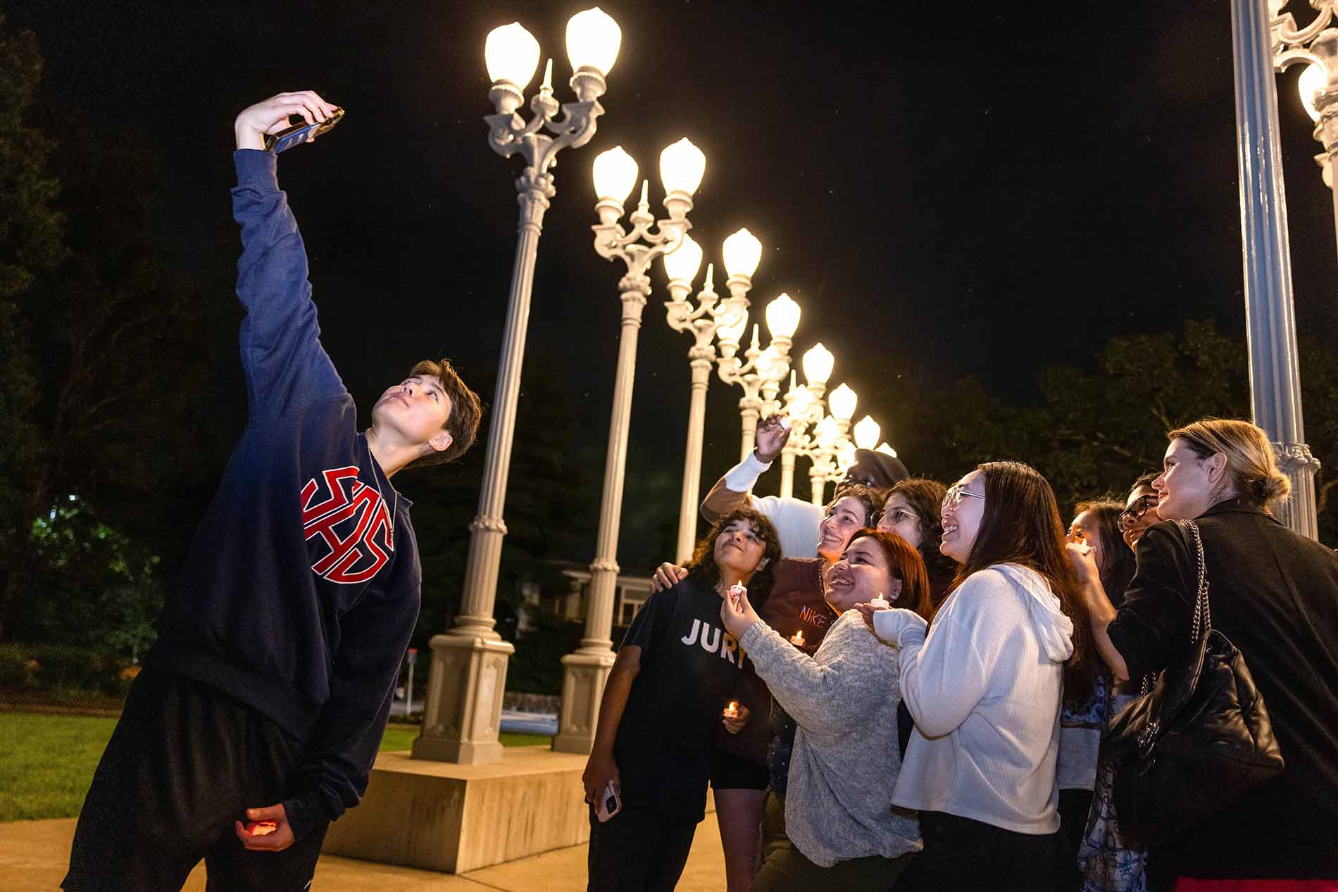 Students taking a selfie outside with the Light of Reason