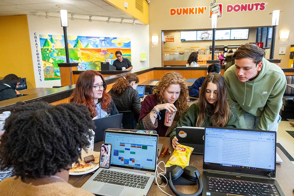 Students look at computers in the student center