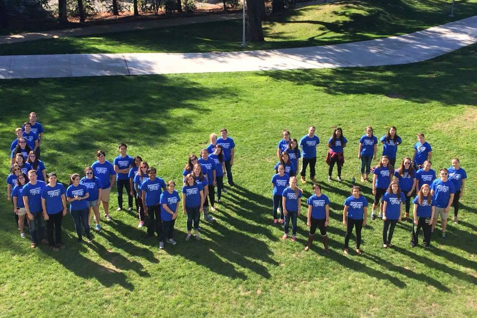 Waltham Group coordinators spell WG on the lawn