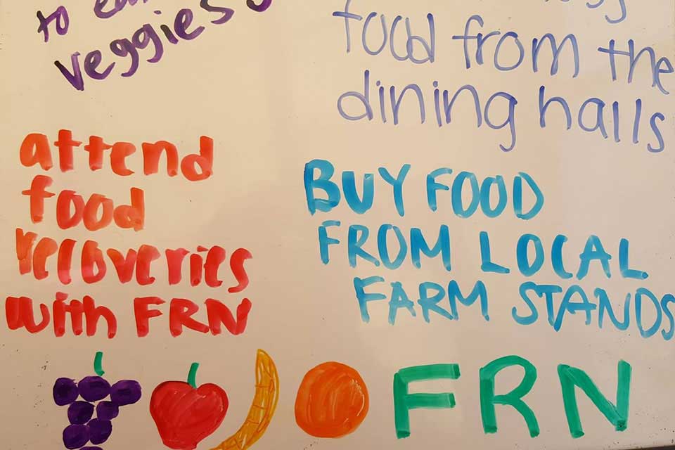 Text on a whiteboard: Attend food recoveries with FRN, Buy food from local farm stands, FRN