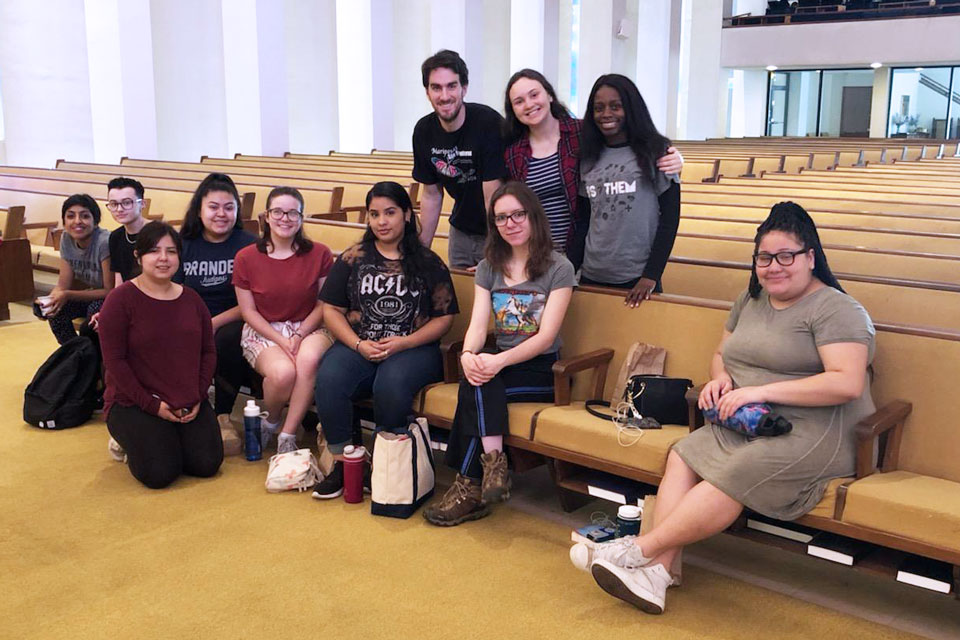 Student Volunteers gathered, sitting in a church.