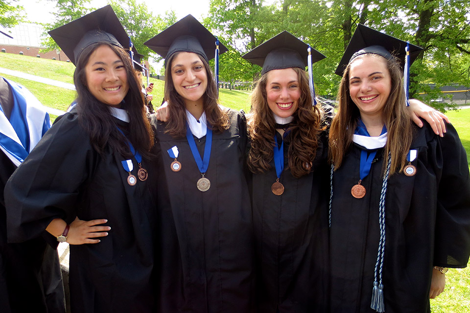 Group shot of Commitment to Service winners wearing caps and gowns at Commencement