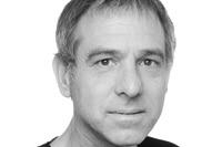 Portrait photo of Ehud Krinis, wearing a black t-shirt