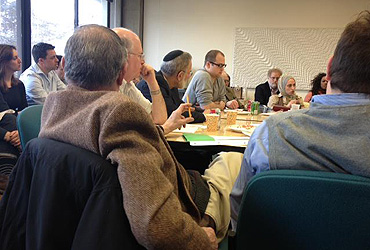 People gather around a conference table