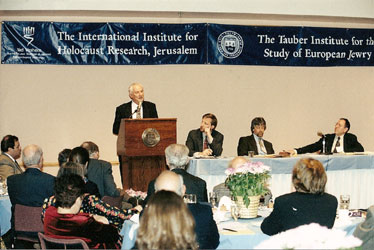 A speaker presents at a podium