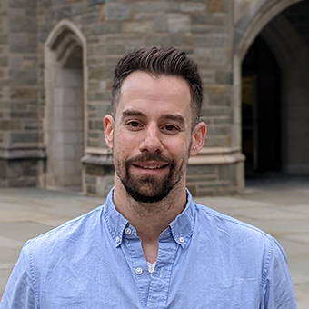 Joshua Picard in front of stone building 