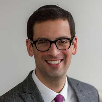 Headshot of David Shyovitz smiling at the camera.