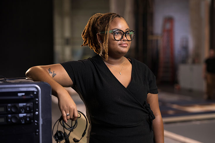 Payton Gunner standing behind the stage.