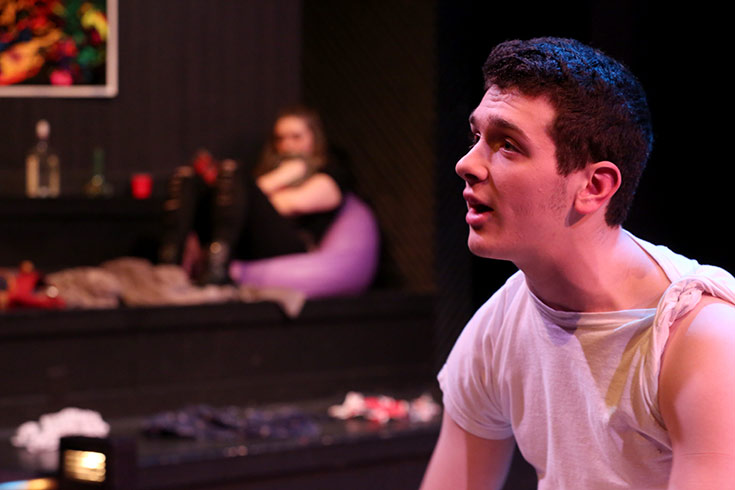 Close up of male student acting in a senior thesis production on stage