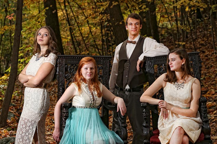 Four theater arts students strike a pose in the woods